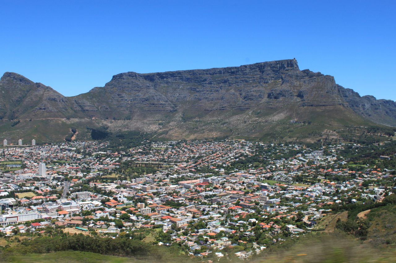 Scenic aerial view of Cape Town cityscape with iconic Table Mountain in the backdrop.